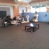 Force plate in teh middle of the room for back to sport evaluations and feedback training